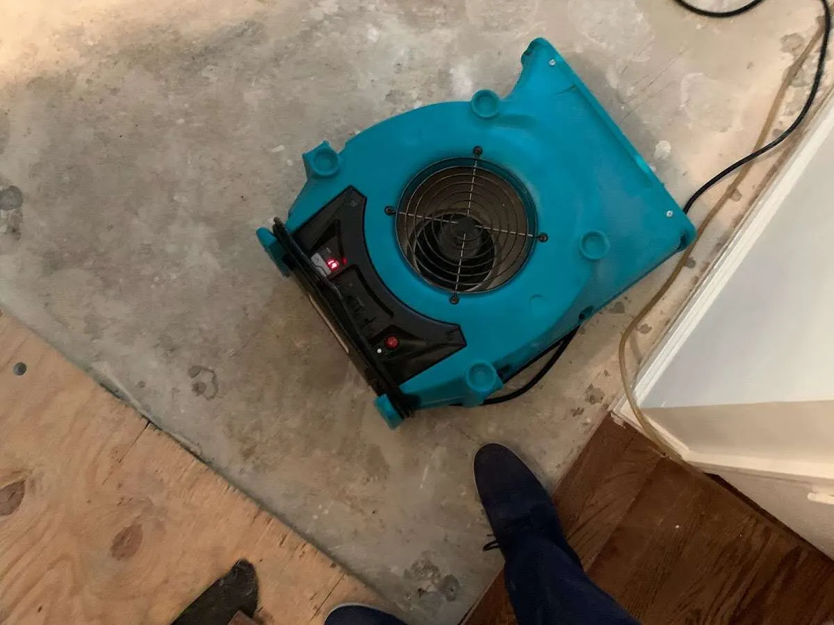 Air mover drying subfloor during Commercial Water Damage Restoration in Logansport